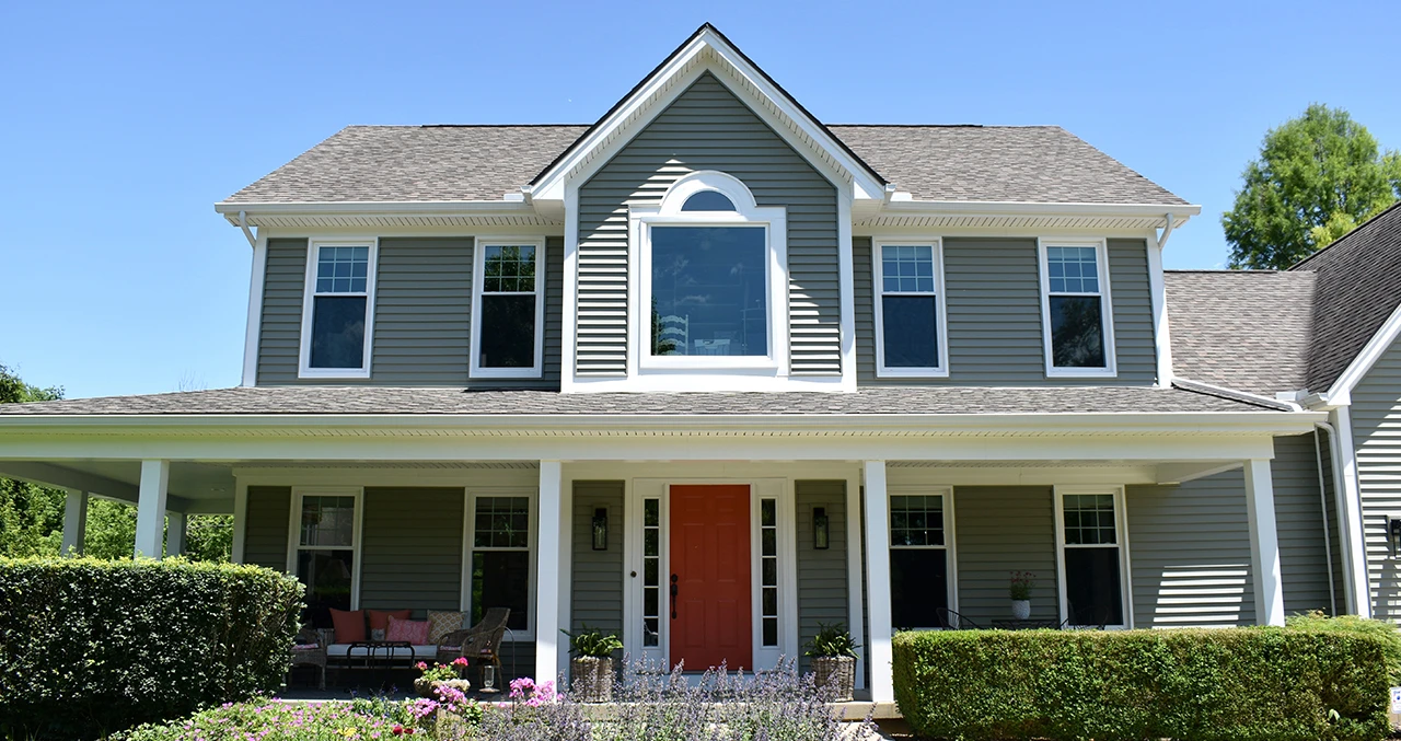 After: same house with new siding and windows without shutters