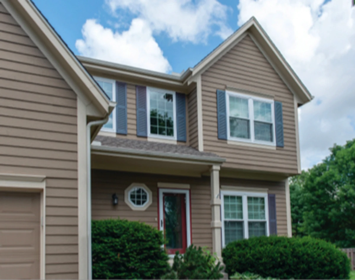 Exterior view: red door with a storm door.