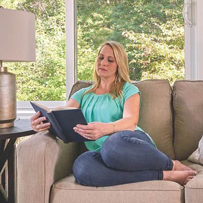 Woman reading a book in her Champion sunroom