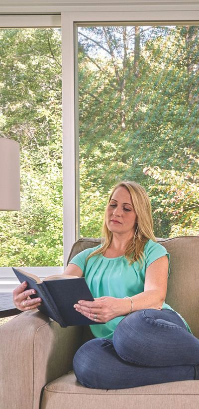 Woman reading a book in her Champion sunroom