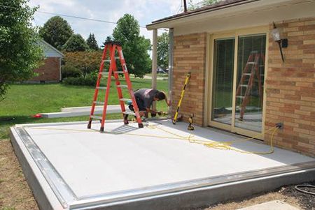 Champion installer putting in sunroom foundation