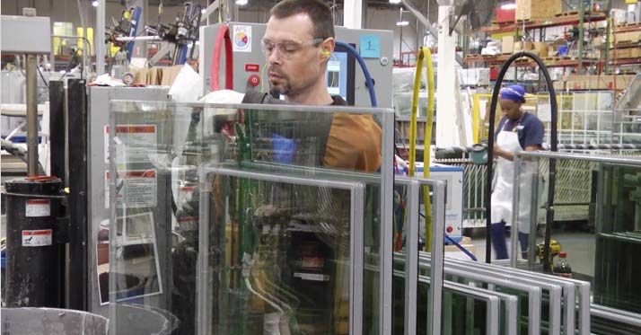 Champion factory employee working on window