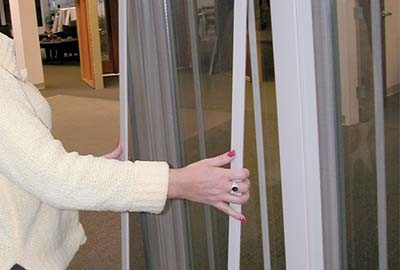 Person removing screen from Champion window