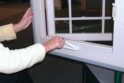 Person using crank to open window