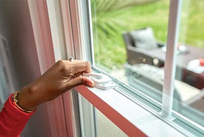 Person raising bottom sash of window