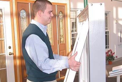 Person reinserting sliding window into frame