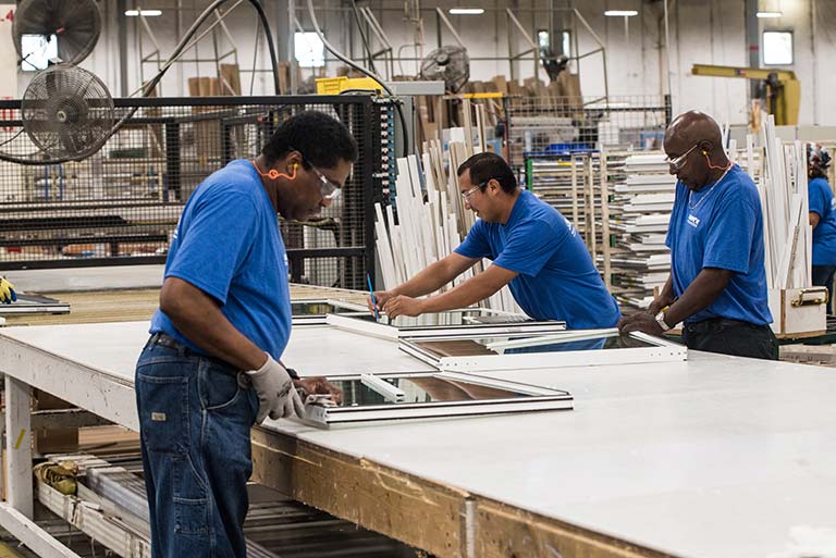 Champion employees glazing windows