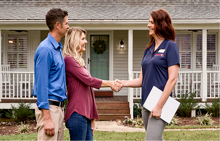 Champion customers shaking hands with their Champion representative.