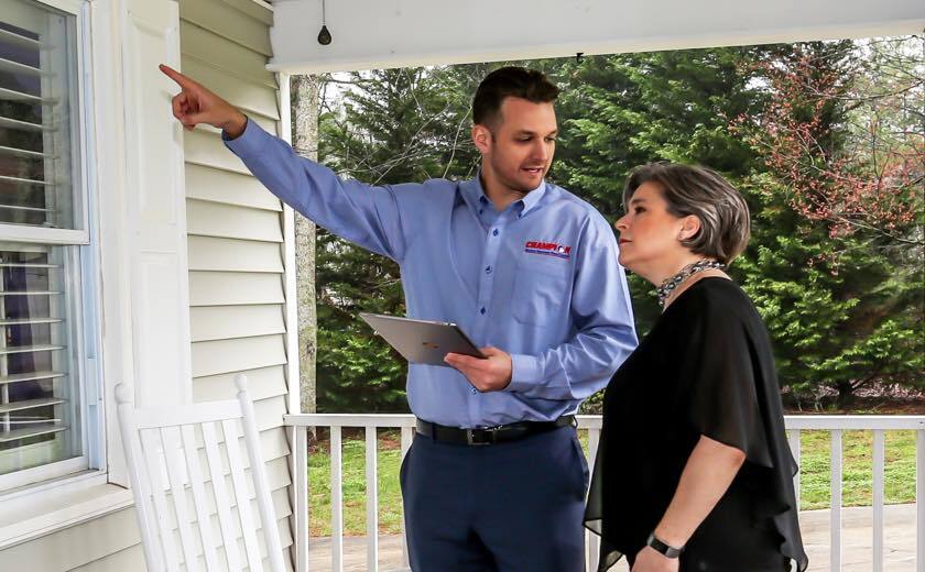 Champion employee reviewing window options with homeowner