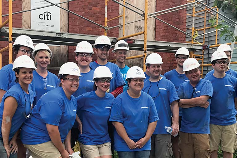 Champion employees in front of construction site